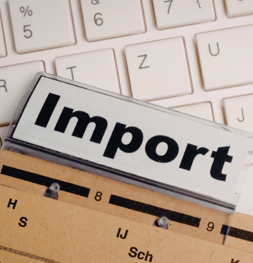 A file folder that says Import on top of a keyboard